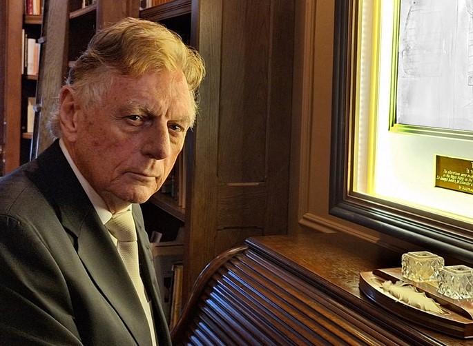 Christopher Reynolds examining plans for HMS Endeavour